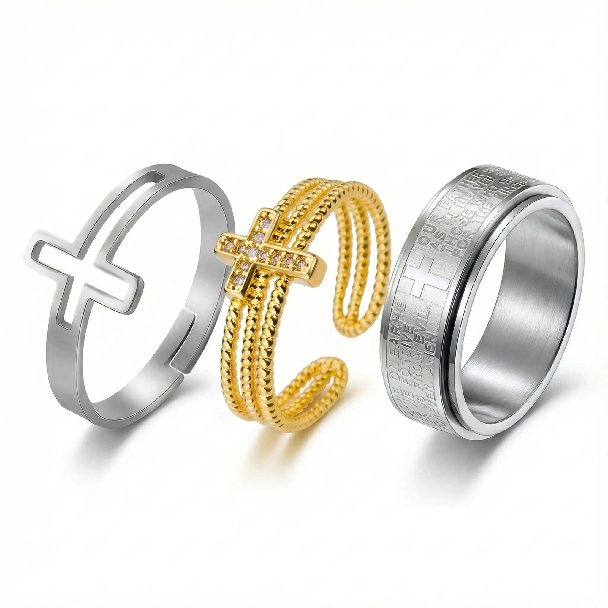 Trio of diverse cross rings: Silver minimalist adjustable sideways cross ring, gold triple-band pave crystal open ring, and wide stainless steel Lord's Prayer spinner ring.