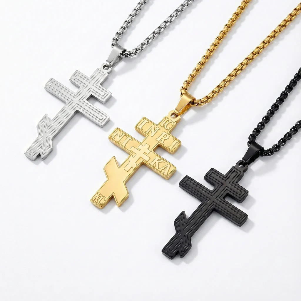 Trio of stainless steel Eastern Orthodox cross necklaces: Silver and black pendants with linear grooves, and a gold-tone cross with traditional IC XC NIKA engravings on box chains.