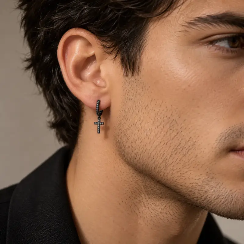 mens black diamond cross earrings varro Black cross hoop earring worn by a dark-haired man in a black jacket, side profile