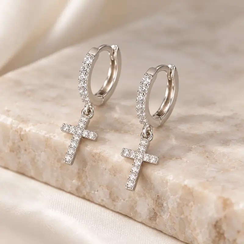 diamond cross earrings for men varro Diamond-look cross earrings for men in silver tone, propped on a beige marble ledge
