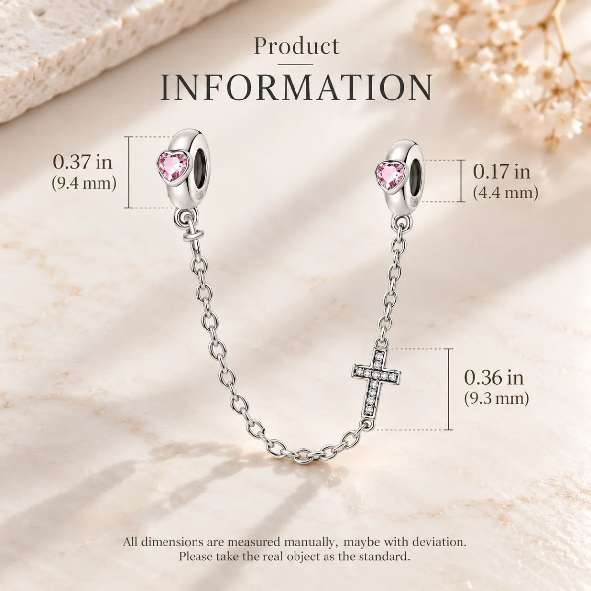 Stopper bead and cross sizes marked on the safety chain against pale marble