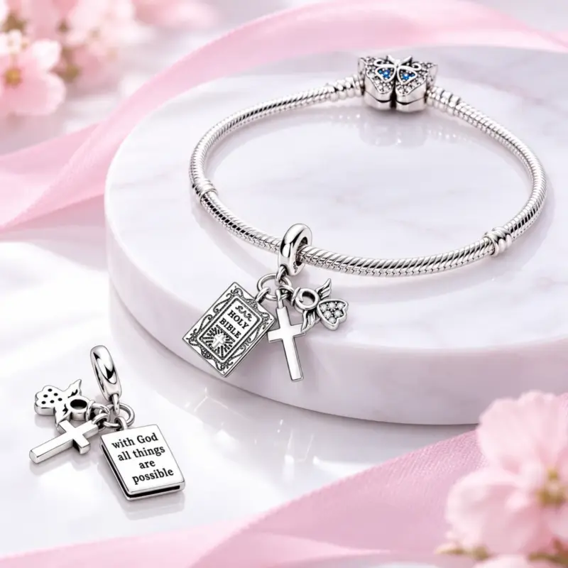 catholic cross charm Catholic dangle charm threaded on a silver snake bracelet, verse side shown on marble