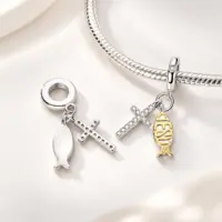 Silver cross and Jesus fish dangle on snake chain bracelet, second charm showing plain back