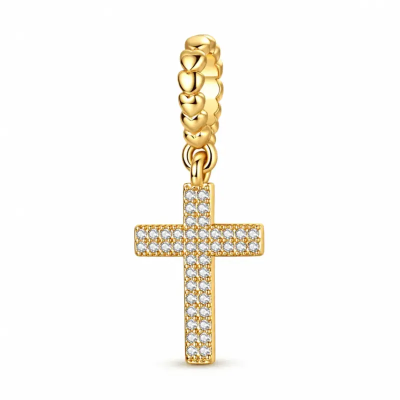 gold diamond cross charm gloria CZ pavé Latin cross in 14k gold plating, hanging from a puffed-heart bail