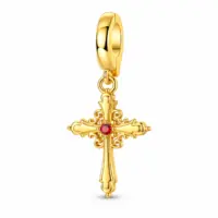 Gold-plated sterling cross charm with red center stone and scrollwork on white background