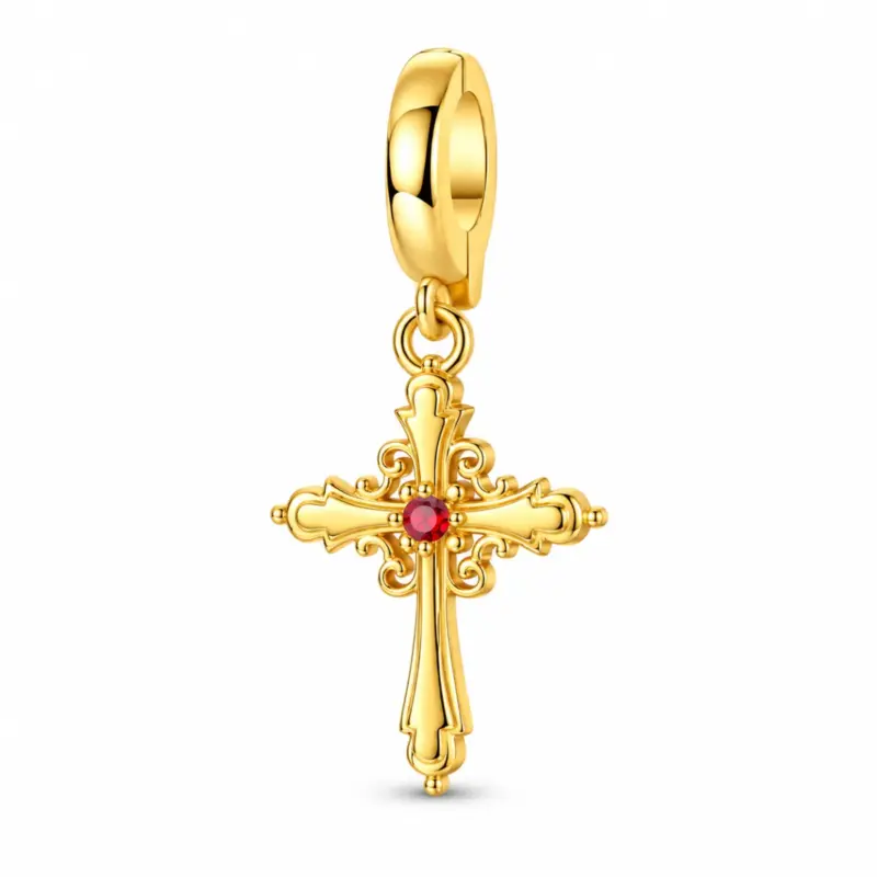 Gold-plated sterling cross charm with red center stone and scrollwork on white background