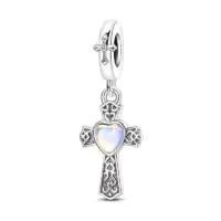 Oxidized sterling silver filigree cross charm with iridescent heart stone at center