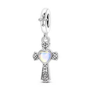 Oxidized sterling silver filigree cross charm with iridescent heart stone at center