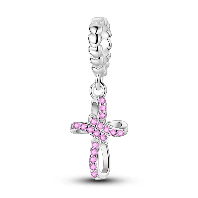 pink-cross-charm-sterling-silver Pink pavé cross charm in sterling silver with an open ribbon loop and beaded bail
