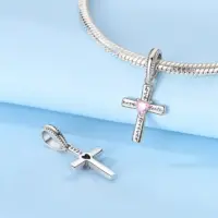 Women's silver scripture cross pendant charm shown on a snake chain bracelet