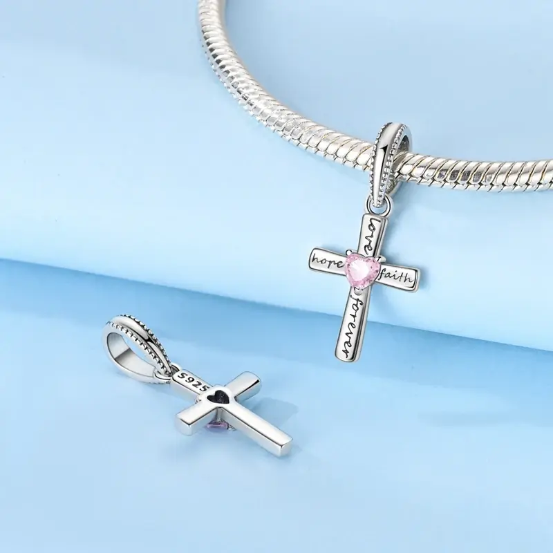 scripture-cross-charm-bracelet Women's silver scripture cross pendant charm shown on a snake chain bracelet