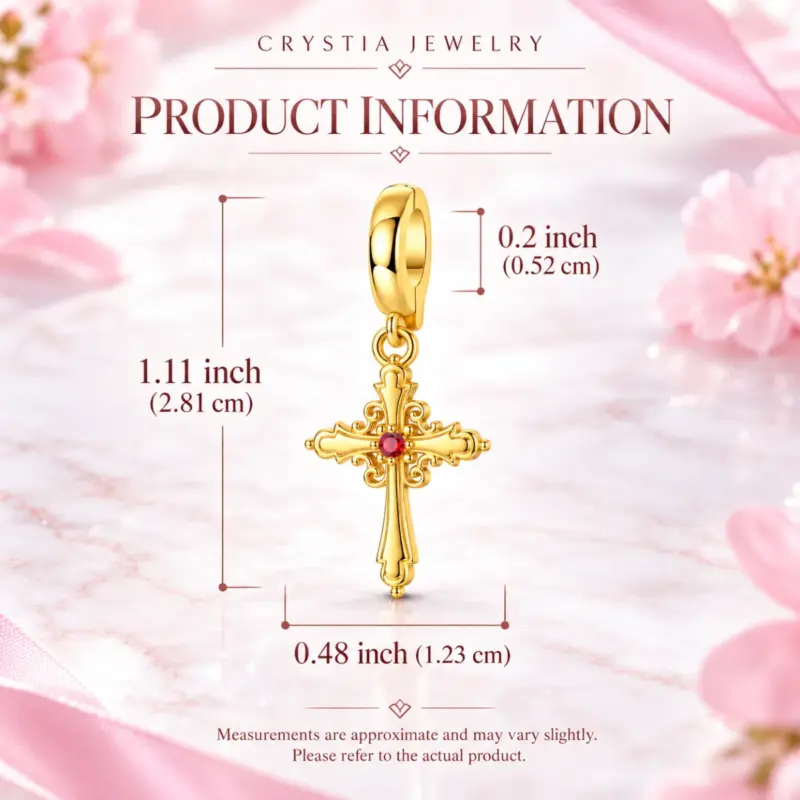 gold plated cross charmâ Dimensions of the scrolled gold cross charm, 1.11 in tall, shown on pink marble