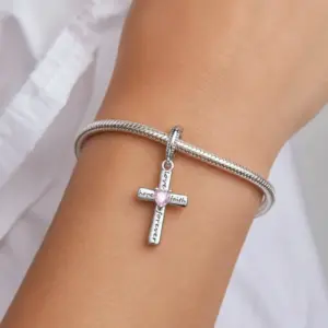 silver faith cross charm at women wrist, sterling silver material