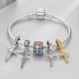 Charm bracelet loaded with pink, silver, rainbow and gold cross charms