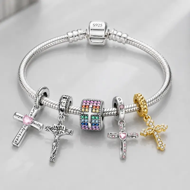 charm-bracelet-with-cross-charms Charm bracelet loaded with pink, silver, rainbow and gold cross charms