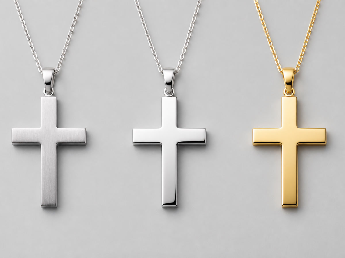 Three Latin cross necklaces in stainless steel, sterling silver, and gold plated