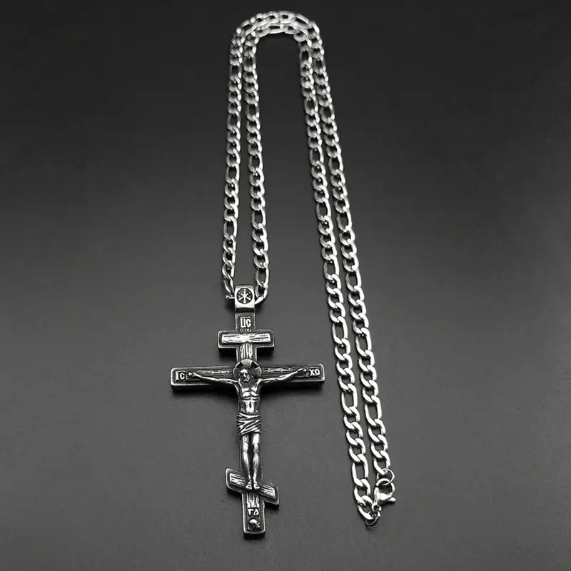 steel-crucifix-figaro-chain-clasp Full steel crucifix necklace laid flat with figaro chain and lobster clasp visible