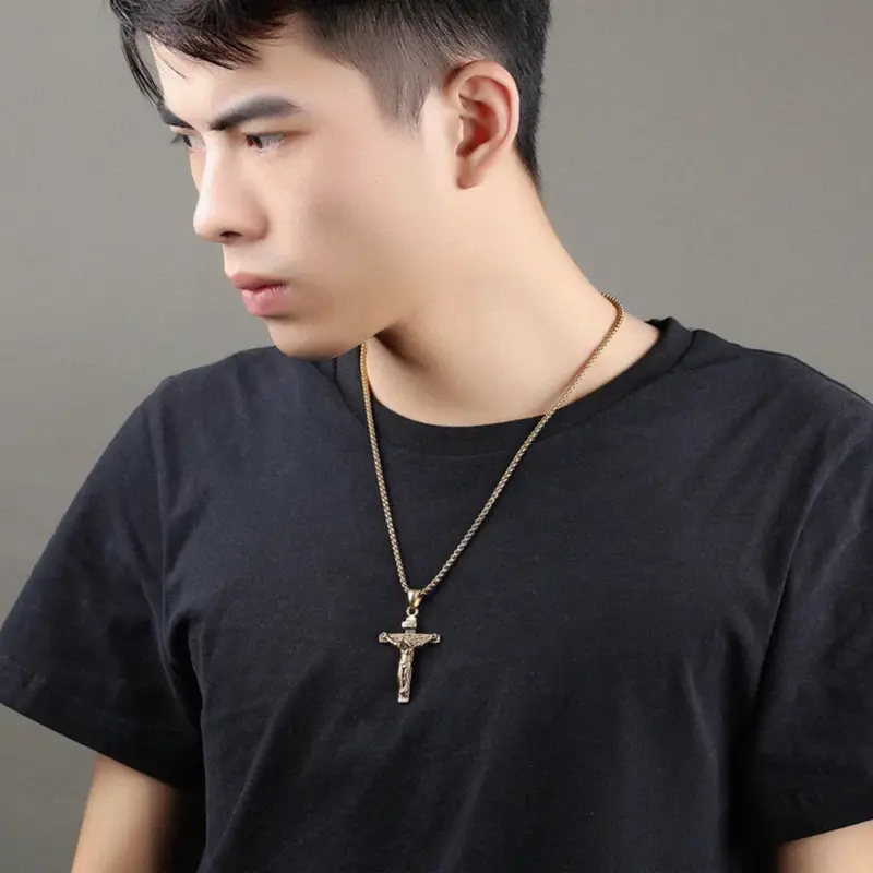 mens-gold-plated-crucifix-worn Man wearing an 18k gold-plated crucifix pendant over a black crew neck tee