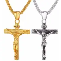 Gold and antiqued silver crucifix pendants shown side by side on wheat chains