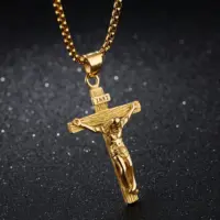 Gold-plated crucifix and wide tube bail on a rounded box chain, dark background