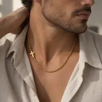 Man wearing the sideways gold cross chain with an open linen shirt in daylight