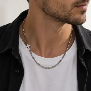 Man wearing the steel offset cross chain over a white tee and black shirt