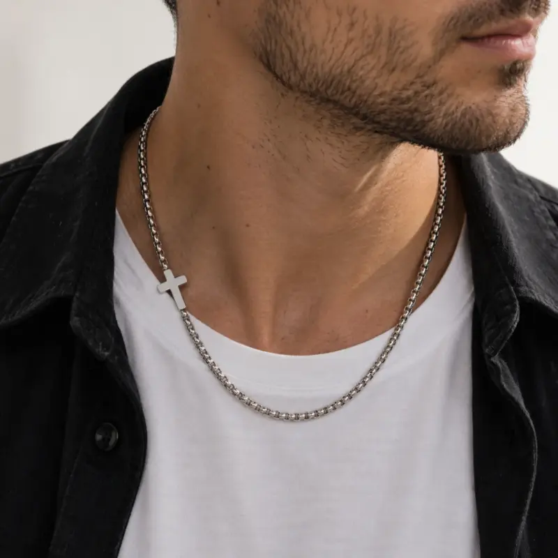 stainless steel sideways cross necklaceâ Man wearing the steel offset cross chain over a white tee and black shirt